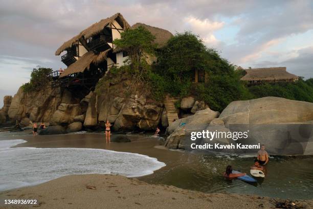 People chillout near a Cabaña built in 1975 by award-winning architect Simón Vélez for Colombian painter Gloria Mejía seen high on the cliff located...