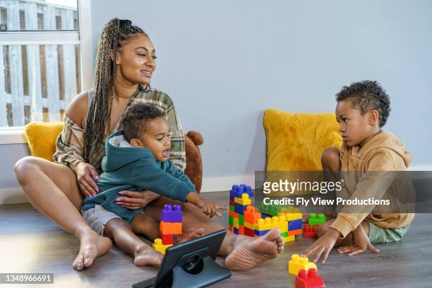 stay at home mom playing with her sons - aunyy stock pictures, royalty-free photos & images