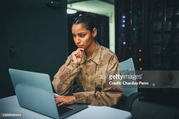 shot of an female it technician  in a server room and using a laptop - female marines stock pictures, royalty-free photos & images