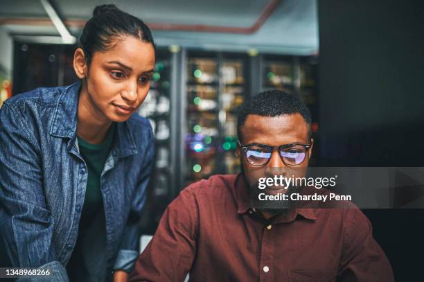shot of a two it technicians working in a server room - help:category stockfoto's en -beelden