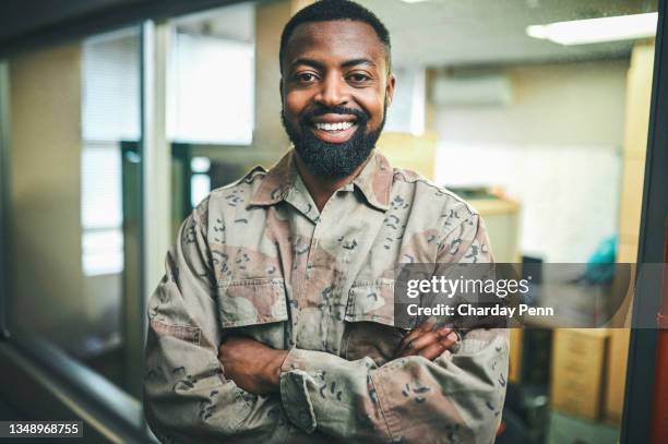 shot of a male soldier standing in a office room - sergeant stock pictures, royalty-free photos & images