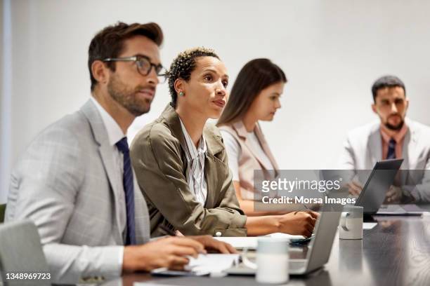 confident colleagues in meeting at office - israeli ethnicity stock pictures, royalty-free photos & images