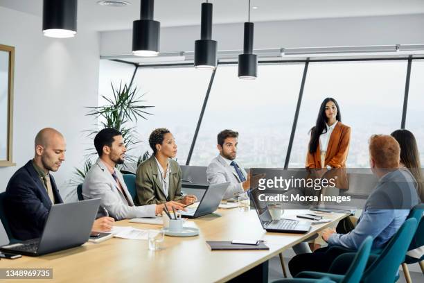 multi-ethnic professionals planning in meeting - board room stock-fotos und bilder