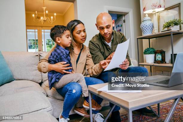 shot of a young couple reviewing their finances while using their laptop - economy stock pictures, royalty-free photos & images