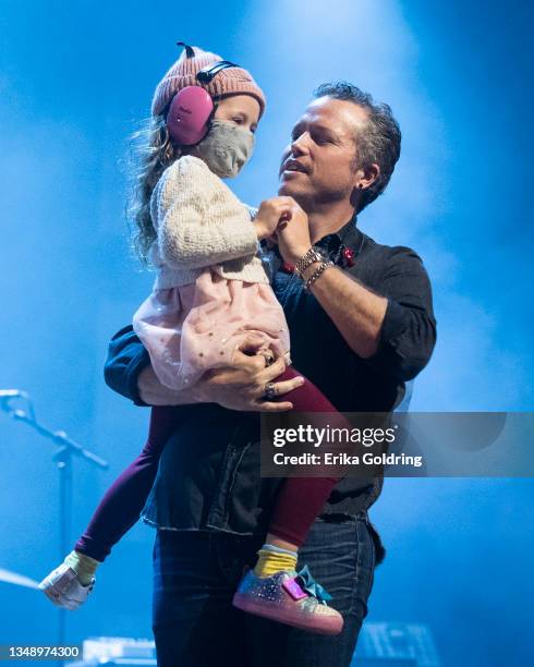 Jason Isbell and his daughter on stage at Ryman Auditorium on October 24, 2021 in Nashville, Tennessee.