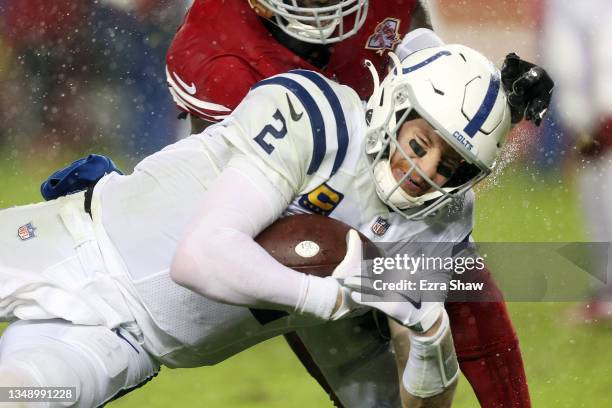 Carson Wentz of the Indianapolis Colts scores a first half touchdown past Jaquiski Tartt of the San Francisco 49ers at Levi's Stadium on October 24,...