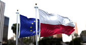 The flags of Poland and the European Union waving in the wind