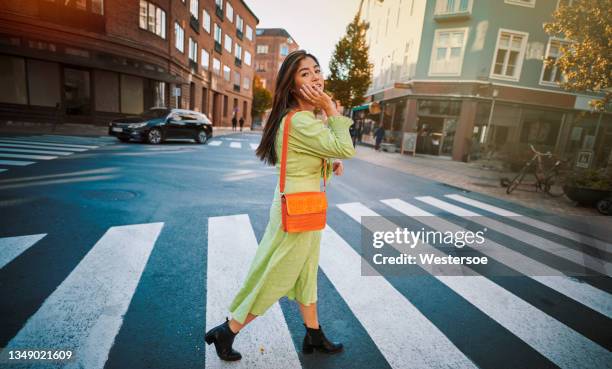 young woman crossing road - vietnamese ethnicity stock pictures, royalty-free photos & images