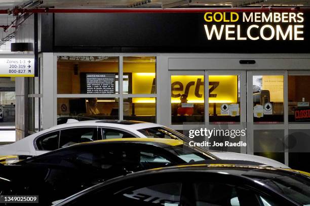Vehicles wait for renters at a Hertz car rental location in the Miami International Airport on October 25, 2021 in Miami, Florida. Hertz announced...