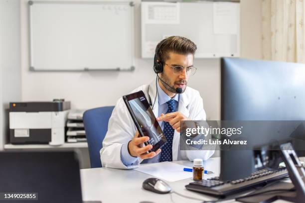 doctor explains patient's tomography on a telemedicine video call - man ipad isolated stock pictures, royalty-free photos & images