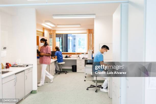 people working in hospital administration department - arztpraxis empfang stock-fotos und bilder