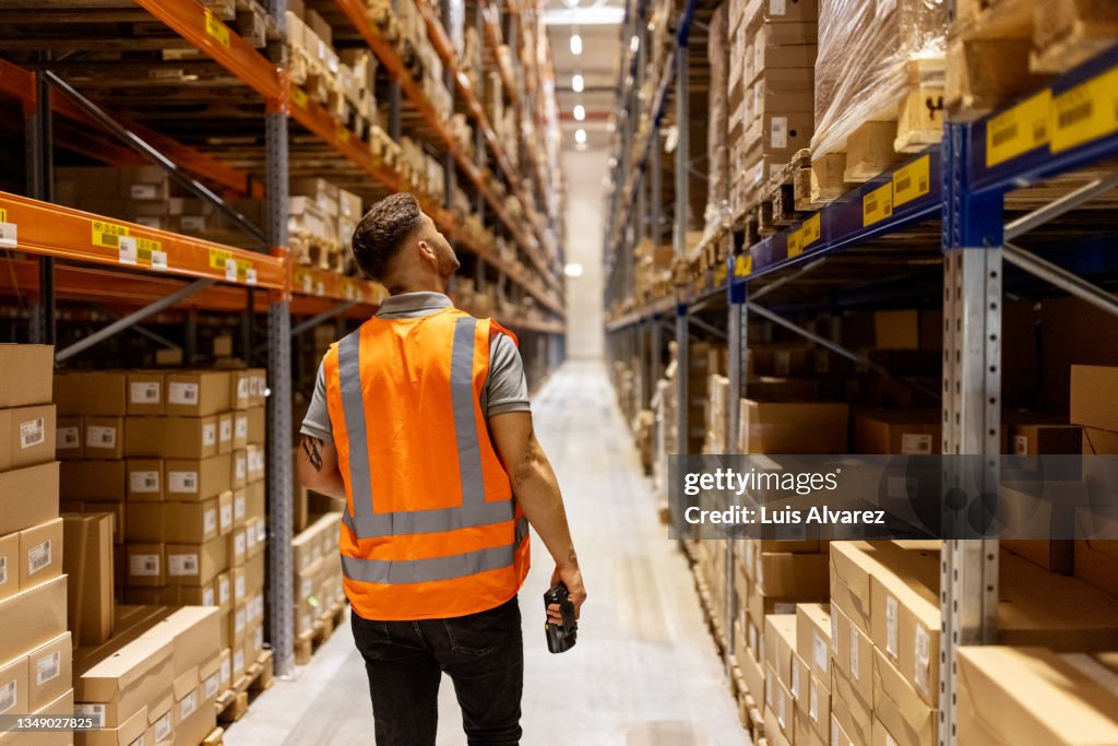 Worker in reflective clothing working in the warehouse