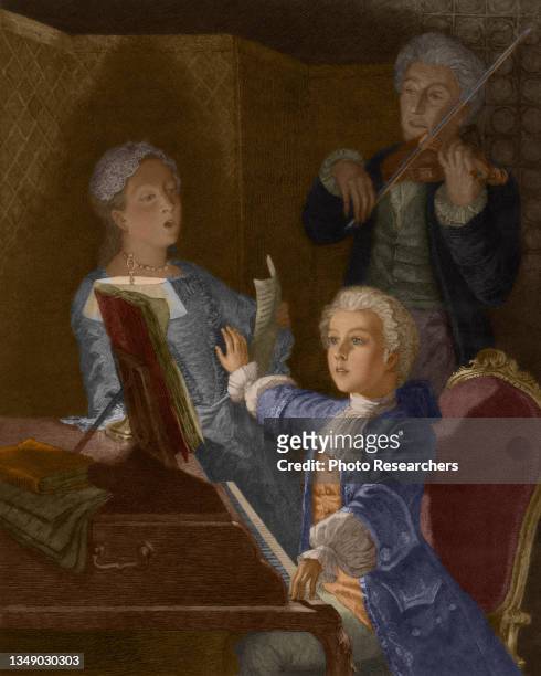 Colorized illustration depicts Austrian composer and musician Wolfgang Amadeus Mozart , as a child, as he plays piano and conducts members of his...