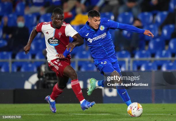 Mathias Olivera of Getafe CF competes for the ball with Joseph Aidoo of RC Celta de Vigo during the LaLiga Santander match between Getafe CF and RC...