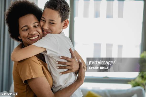 portrait of mother and son - boy hug stock pictures, royalty-free photos & images