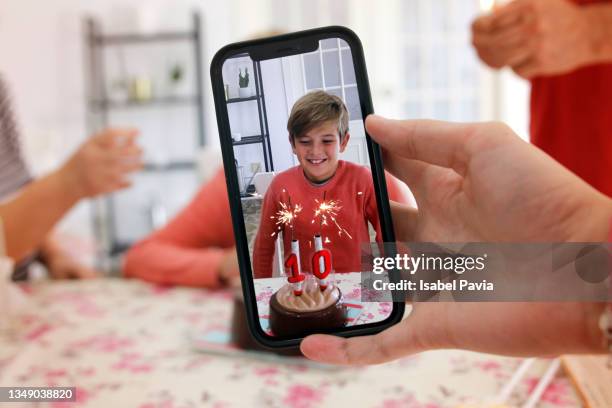 taking photo of boy at birthday party - boy pre adolescent phone hand foto e immagini stock