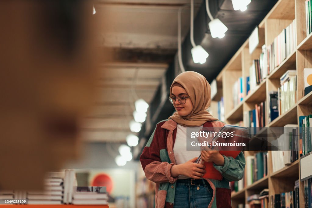 Young student woman in library