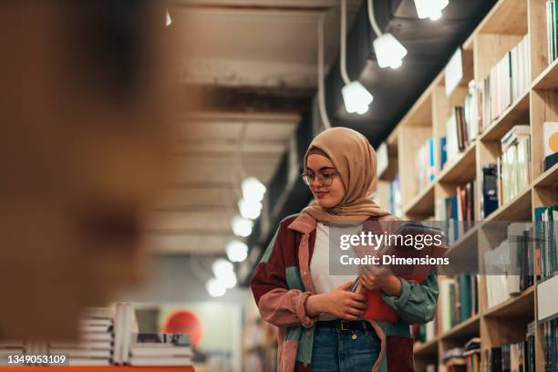 young student woman in library - muslim student stock pictures, royalty-free photos & images