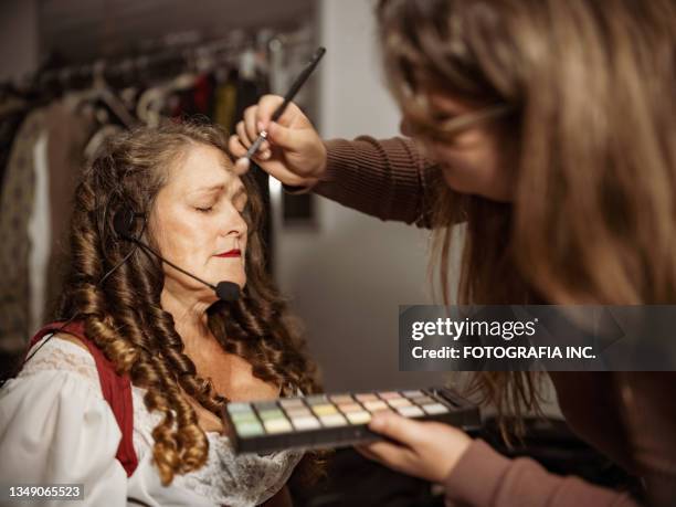 mature actress in period costume doing make up - theatre dressing room stock pictures, royalty-free photos & images