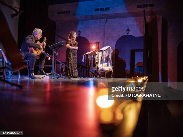 mature performer and guitarist on the stage - opera stage stock pictures, royalty-free photos & images