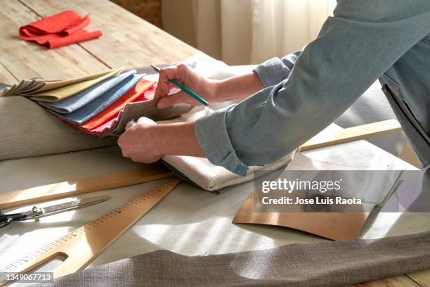 interior designer browsing fabric swatches - interior designer stock pictures, royalty-free photos & images