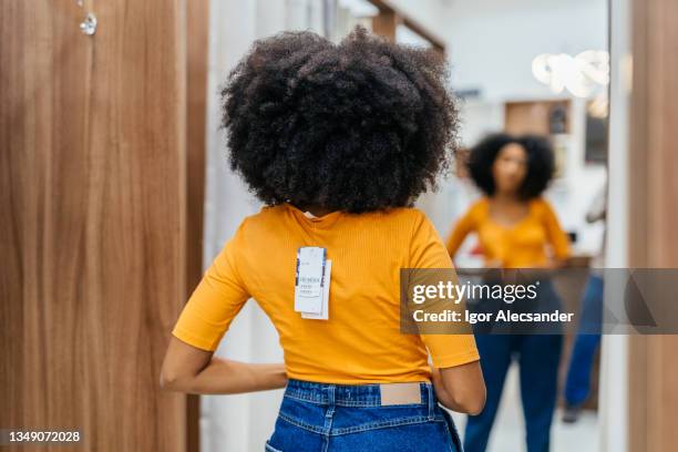 woman trying on an outfit in the store - dressing room stock pictures, royalty-free photos & images