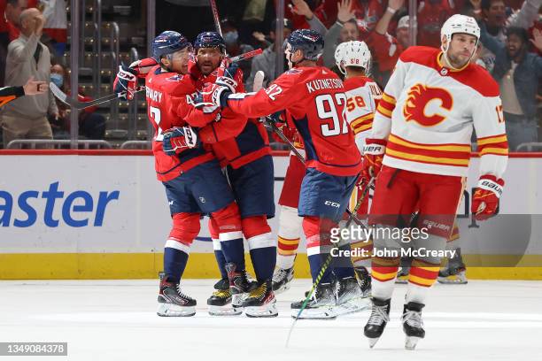 Martin Fehervary of the Washington Capitals celebrates his first NHL goal with Alex Ovechkin and Evgeny Kuznetsov during a game against the Calgary...