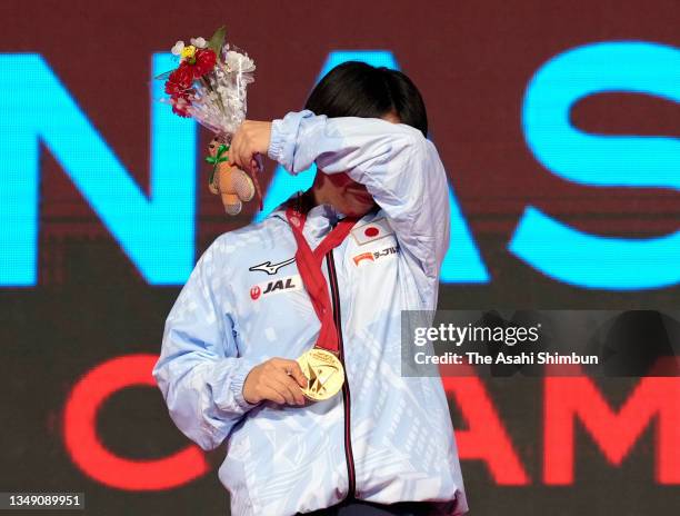 Gold medalist Mai Murakami of Japan wipes her face at the victory ceremony for the Women's Floor during the Apparatus Finals on day seven of the 50th...