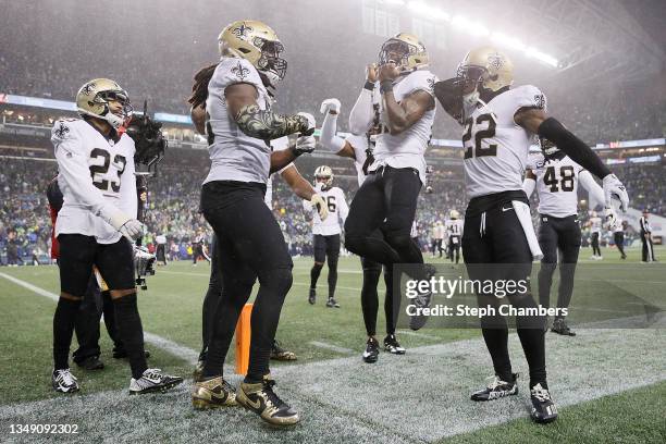 Malcolm Jenkins of the New Orleans Saints celebrates with Demario Davis following a defensive stop against the Seattle Seahawks at Lumen Field on...