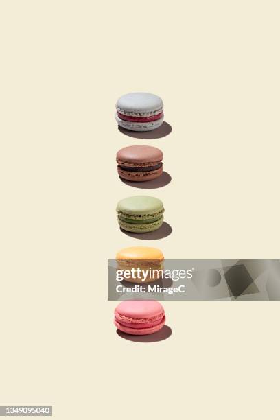 colorful macaroons arranged on beige background - biskvi bildbanksfoton och bilder