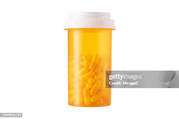 prescription medicine pill bottle full of capsules isolated on white - medicine dose stock pictures, royalty-free photos & images