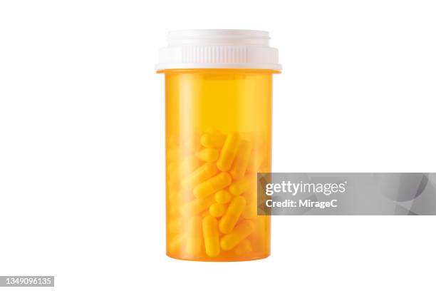 prescription medicine pill bottle full of capsules isolated on white - prescription imagens e fotografias de stock