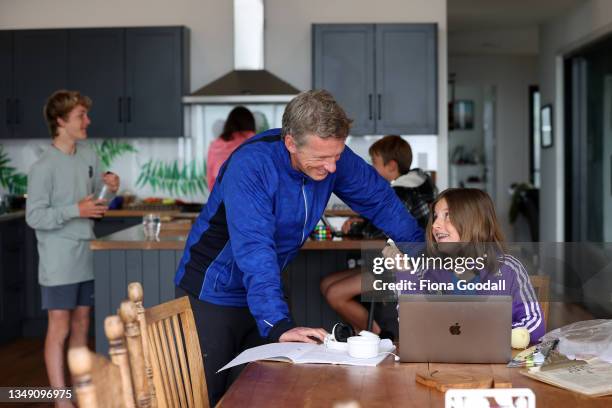 Jessica Matthews, 10 does her school work online in the family kitchen in Warkworth with help from dad Charlie Matthews on October 26, 2021 in...