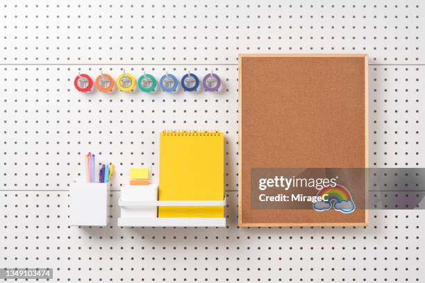 bulletin board with stationary hanging on pegboard - vetrinetta foto e immagini stock