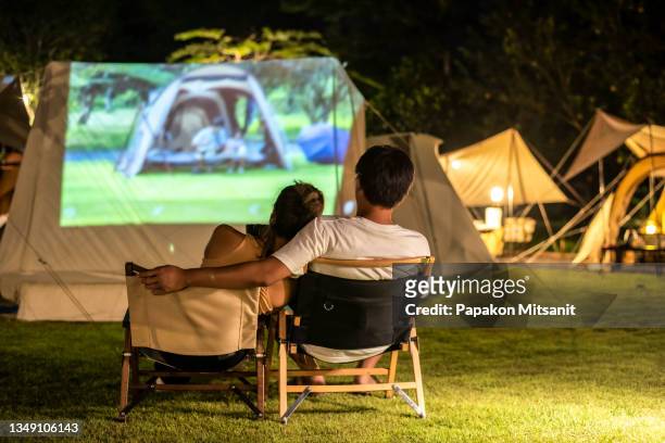 watch a movie at the camping - asian watching movie stockfoto's en -beelden