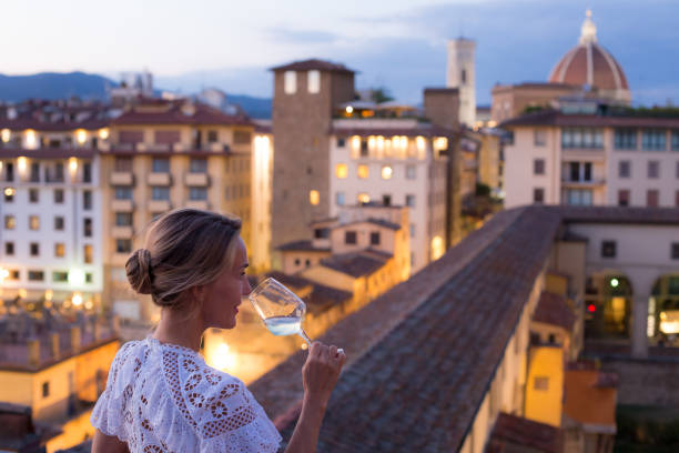 woman in beautiful white dress enjoying a glass of wine with the view of florence - italy stock pictures, royalty-free photos & images
