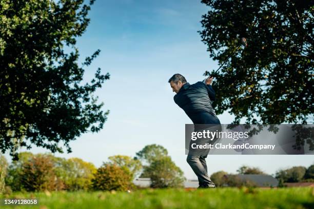 perfect golf swing off the tee. - golf swing sunset stock pictures, royalty-free photos & images