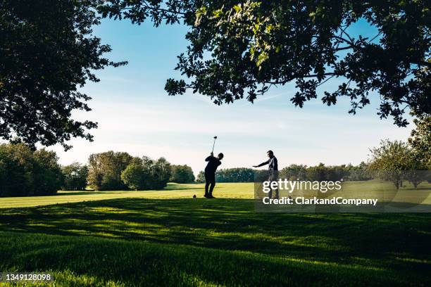 golf coach giving a lesson. - golf bildbanksfoton och bilder