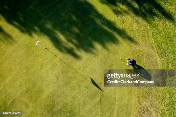 on the putting green aerial view - golf stock pictures, royalty-free photos & images