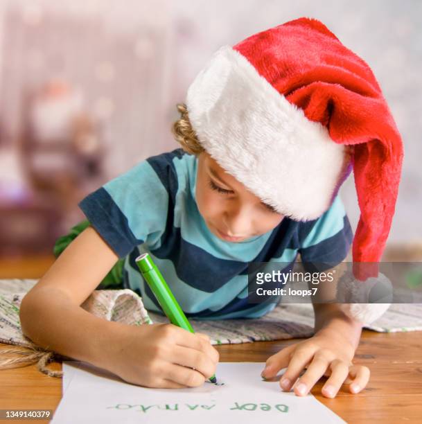 little boy writing a christmas letter to santa - bois noel stock pictures, royalty-free photos & images