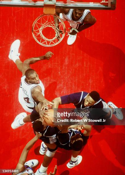 UConn's Scott Burrell, left, contests Georgetown's Alonzo Mourning and Dikembe Mutombo for a rebound, Hartford CT 1991.