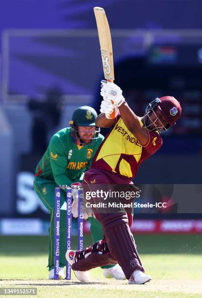 Evin Lewis of West Indies plays a shot as Heinrich Klaasen of South Africa looks on during the ICC Men's T20 World Cup match between South Africa and...