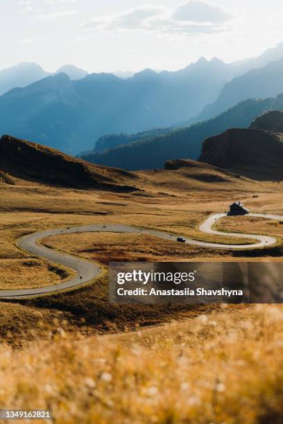 scenic autumn sunset above the mountain pass in the alps - road trip stock pictures, royalty-free photos & images