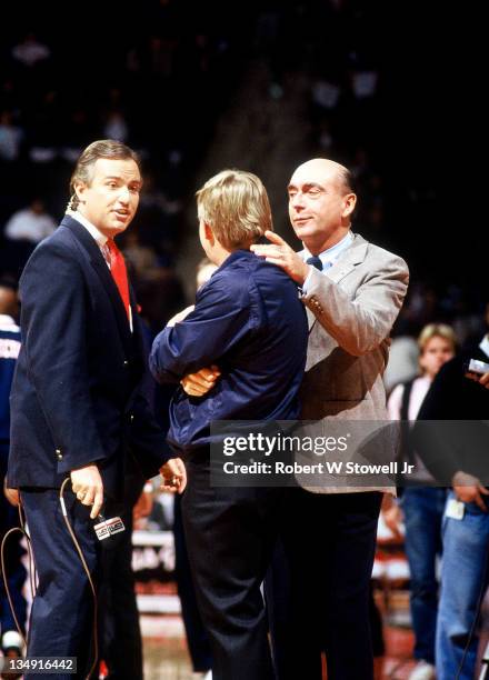 S Tim Brando, left, and Dick Vitale talk to referee prior to the start of a University of Connecticut basketball game, Hartford CT 1992.