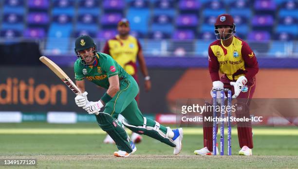Reeza Hendricks of South Africa plays a shot as Nicholas Pooran of West Indies looks on during the ICC Men's T20 World Cup match between South Africa...