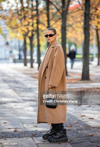 Alessa Winter is seen wearing black boots Miu Miu, Lala Berlin leather pants, Edited jumper, beige Weekday coat, Prada bag and sunglasses on October...