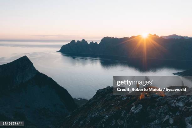 tourist with tent watching sunrise from mountain top, norway - fog camper stock pictures, royalty-free photos & images