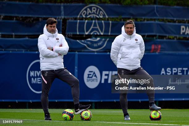 Head coach Mauricio Pochettino and assistant coach Miguel D'Agostino look on during a Paris Saint-Germain training session at Ooredoo Center on...