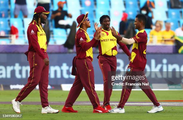 Akeal Hosein of West Indies celebrates the wicket of Reeza Hendricks of South Africa with team mate Shimron Hetmyer during the ICC Men's T20 World...