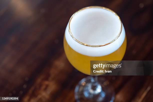 a glass of light beer on bar - real ale stock-fotos und bilder